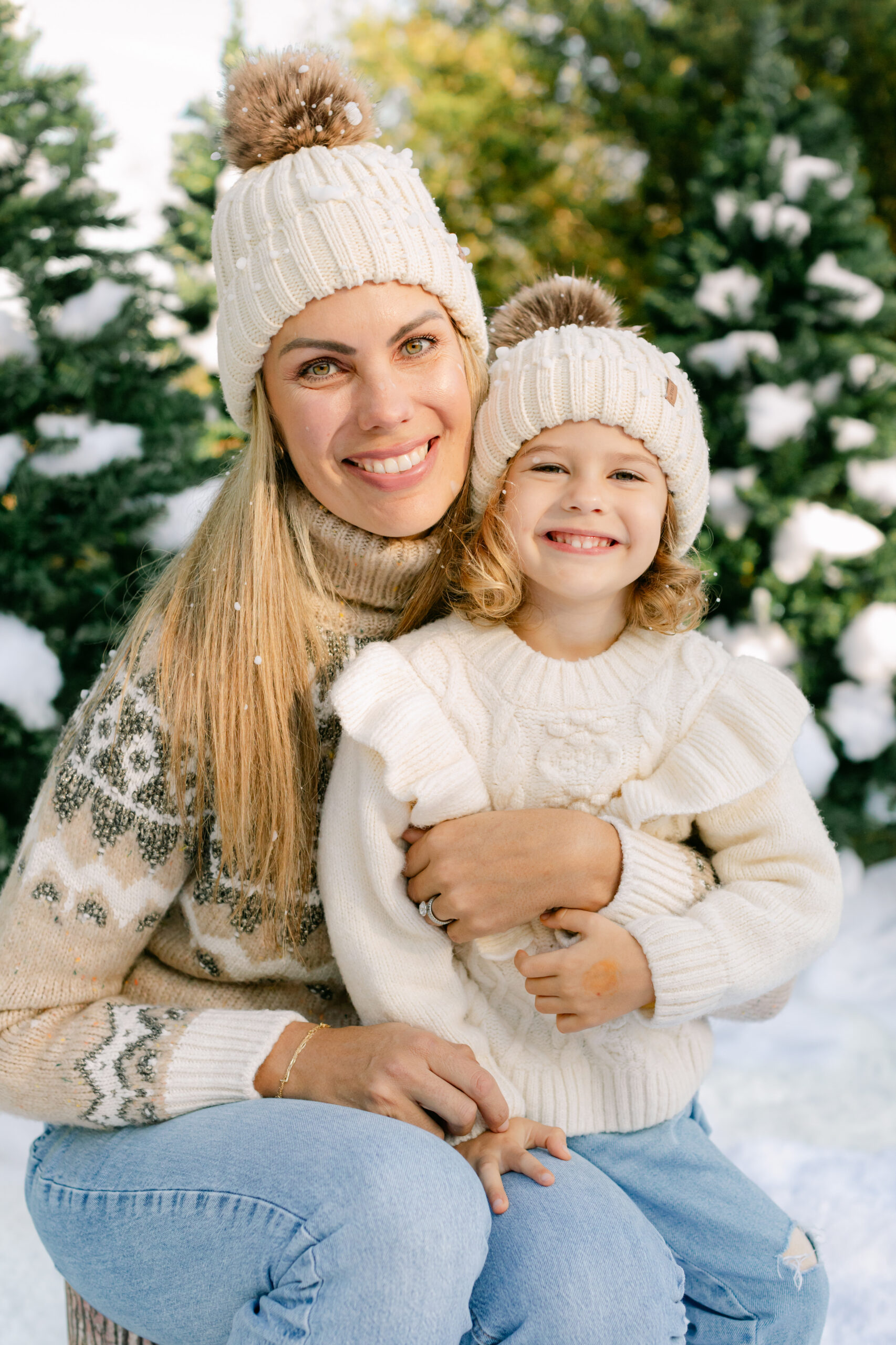 mom and daughter during snow minis christmas family photos