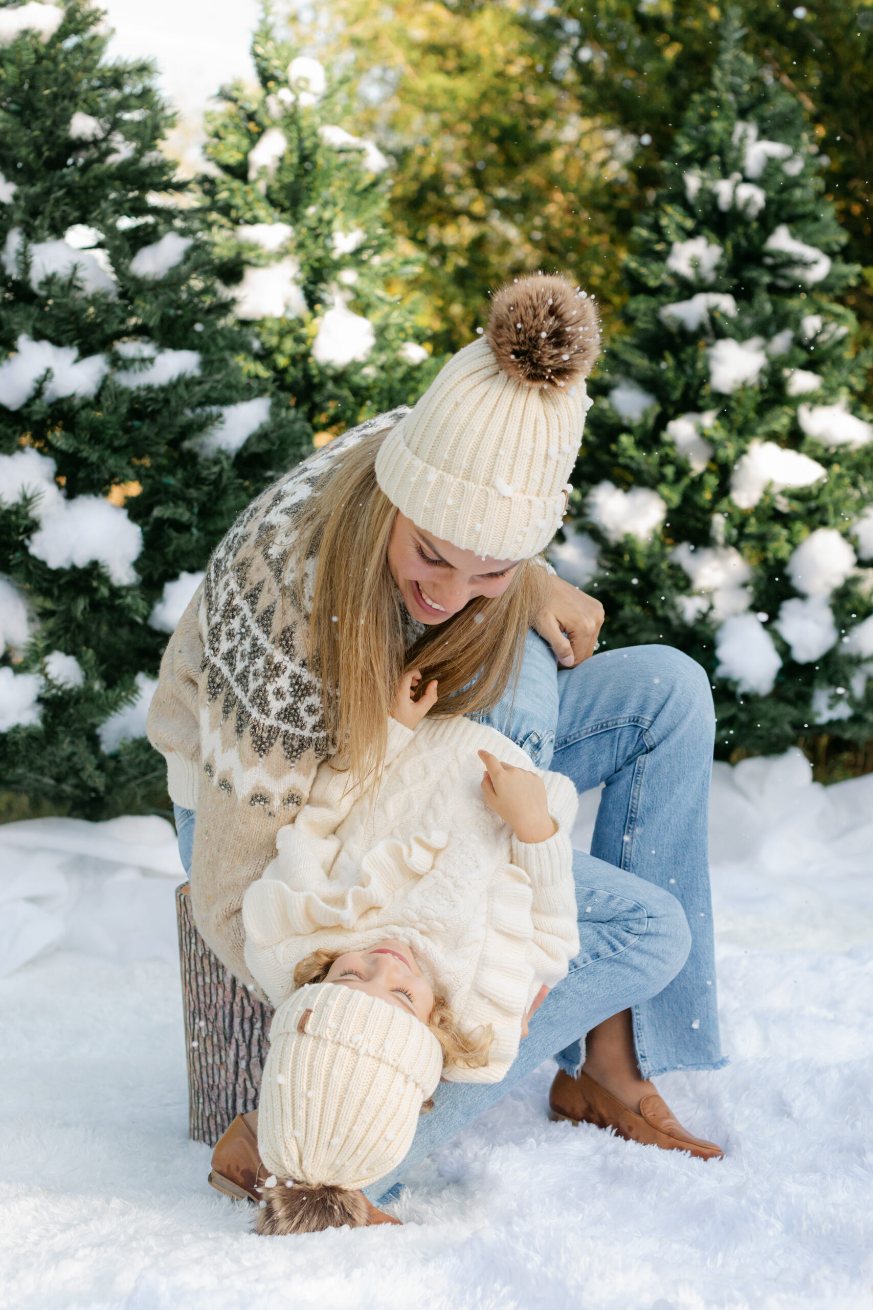 mom and daughter during snow minis christmas family photos