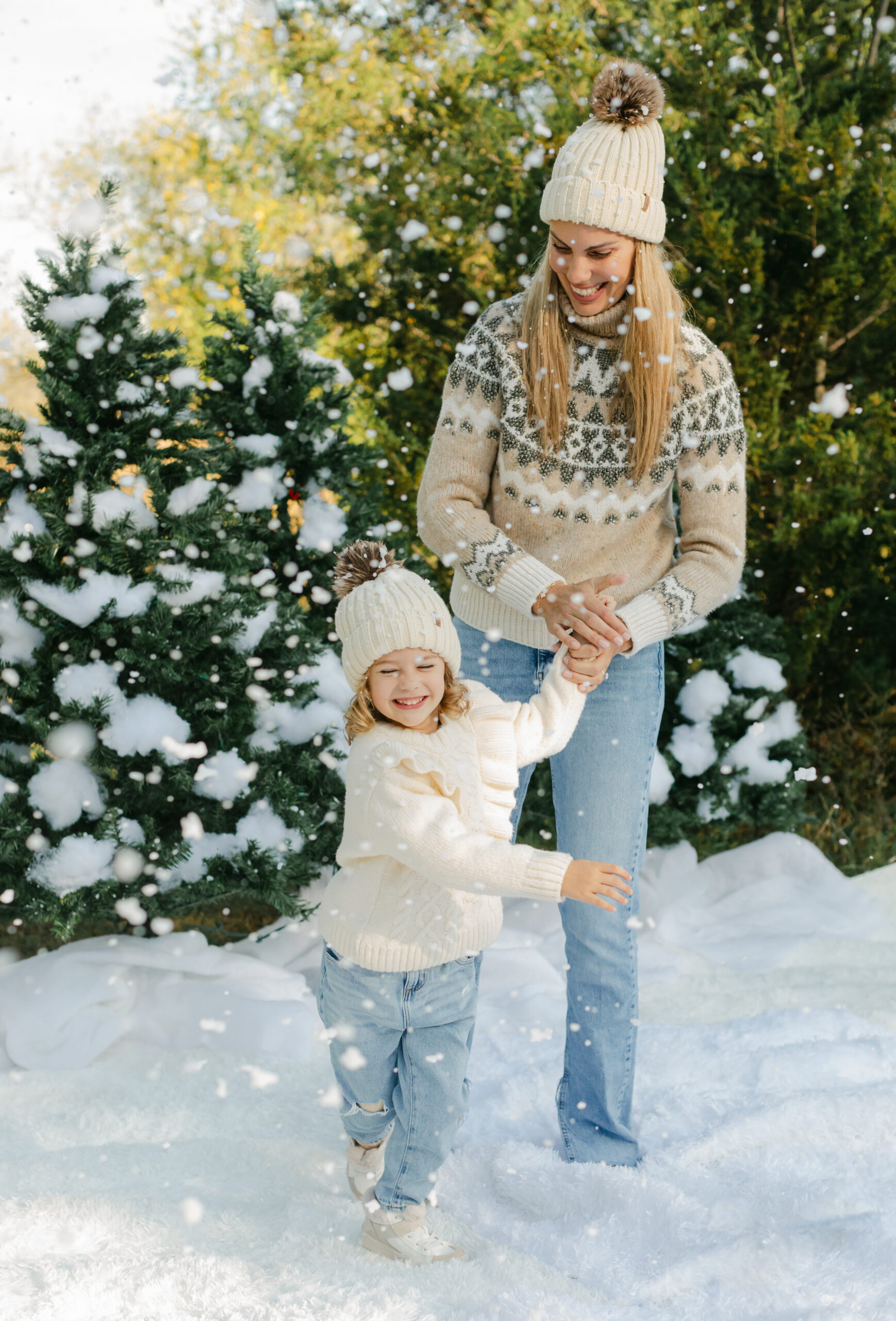 mom and daughter during snow minis christmas family photos