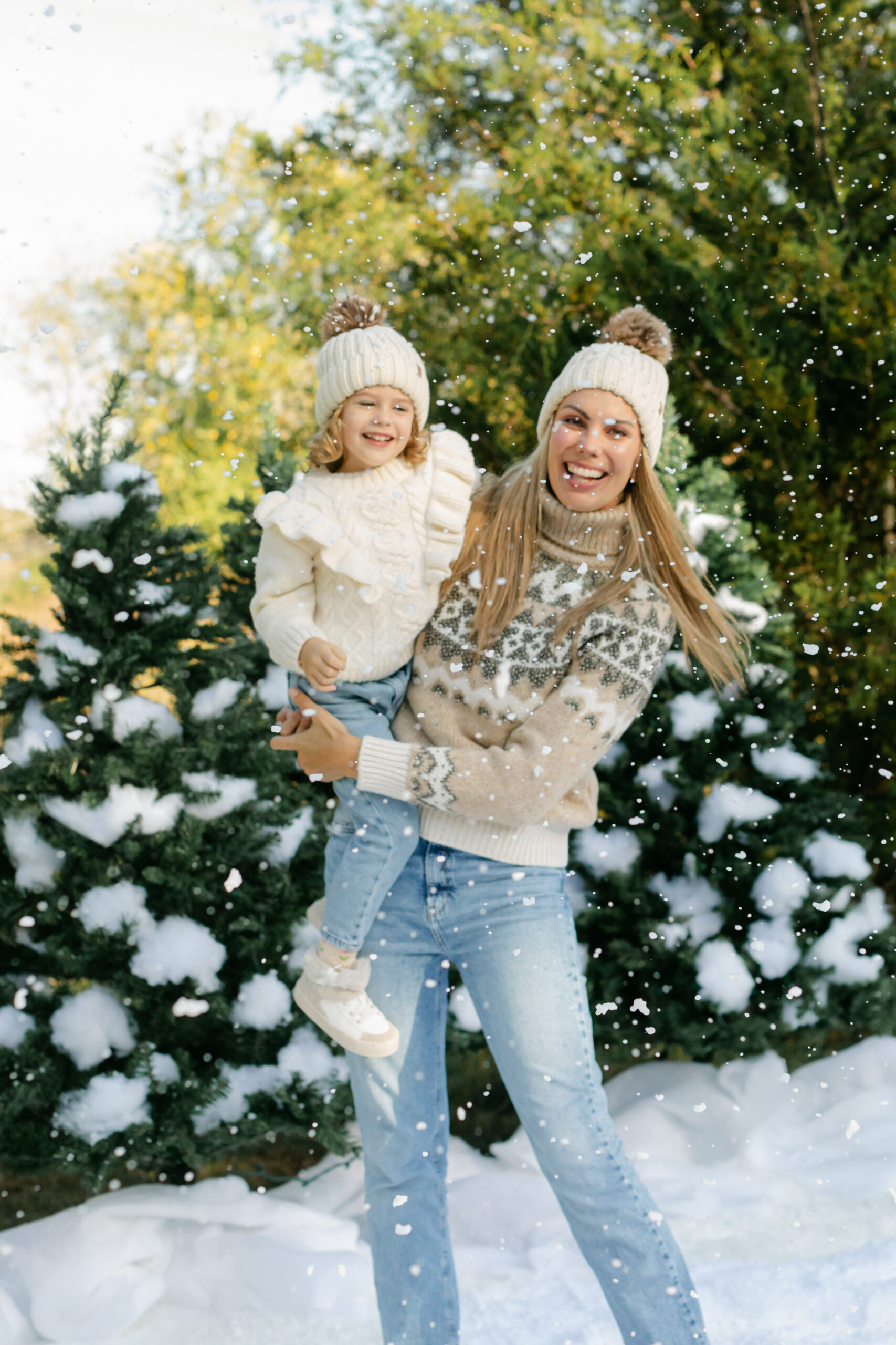 mom and daughter during snow minis christmas family photos