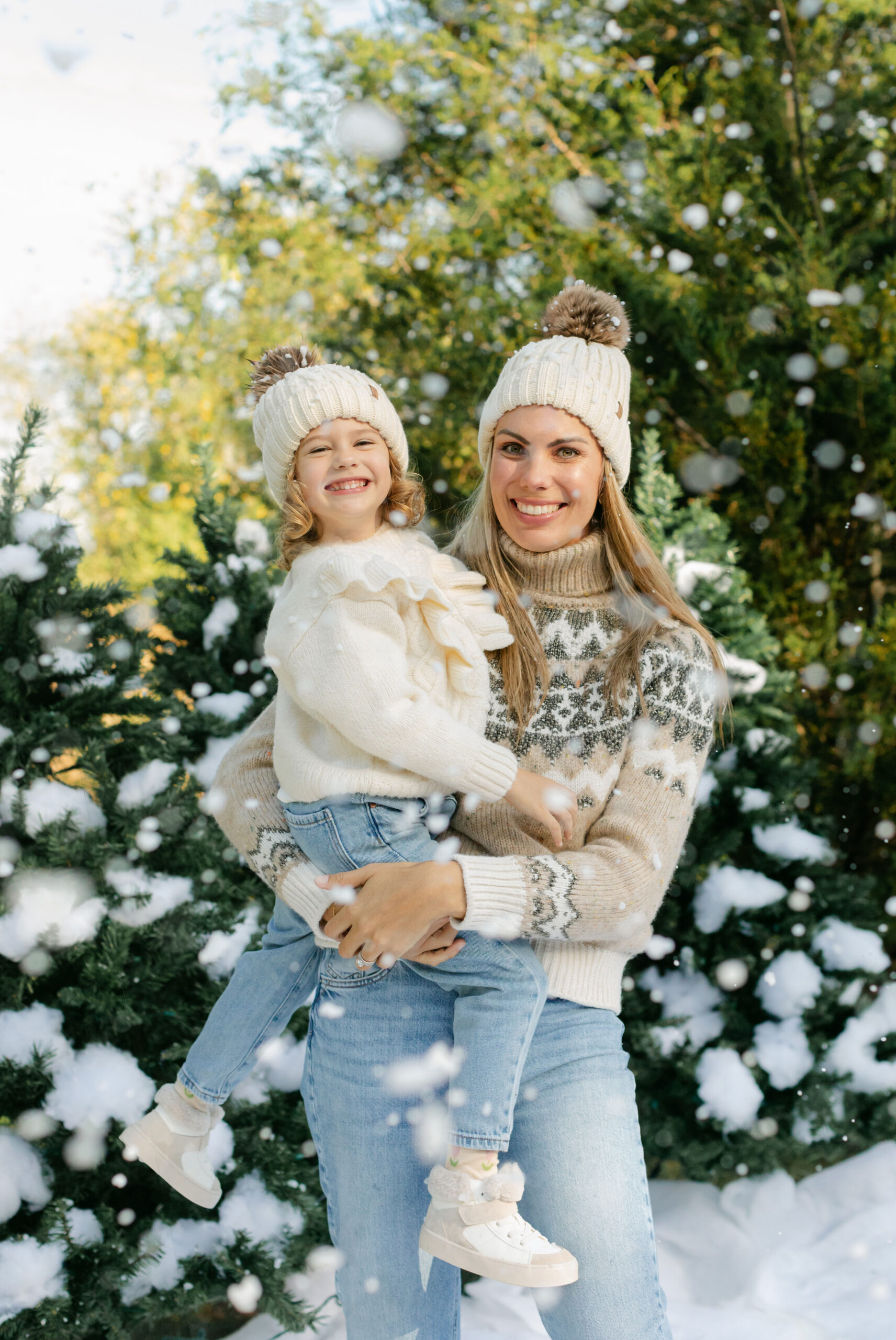 mom and daughter during snow minis christmas family photos