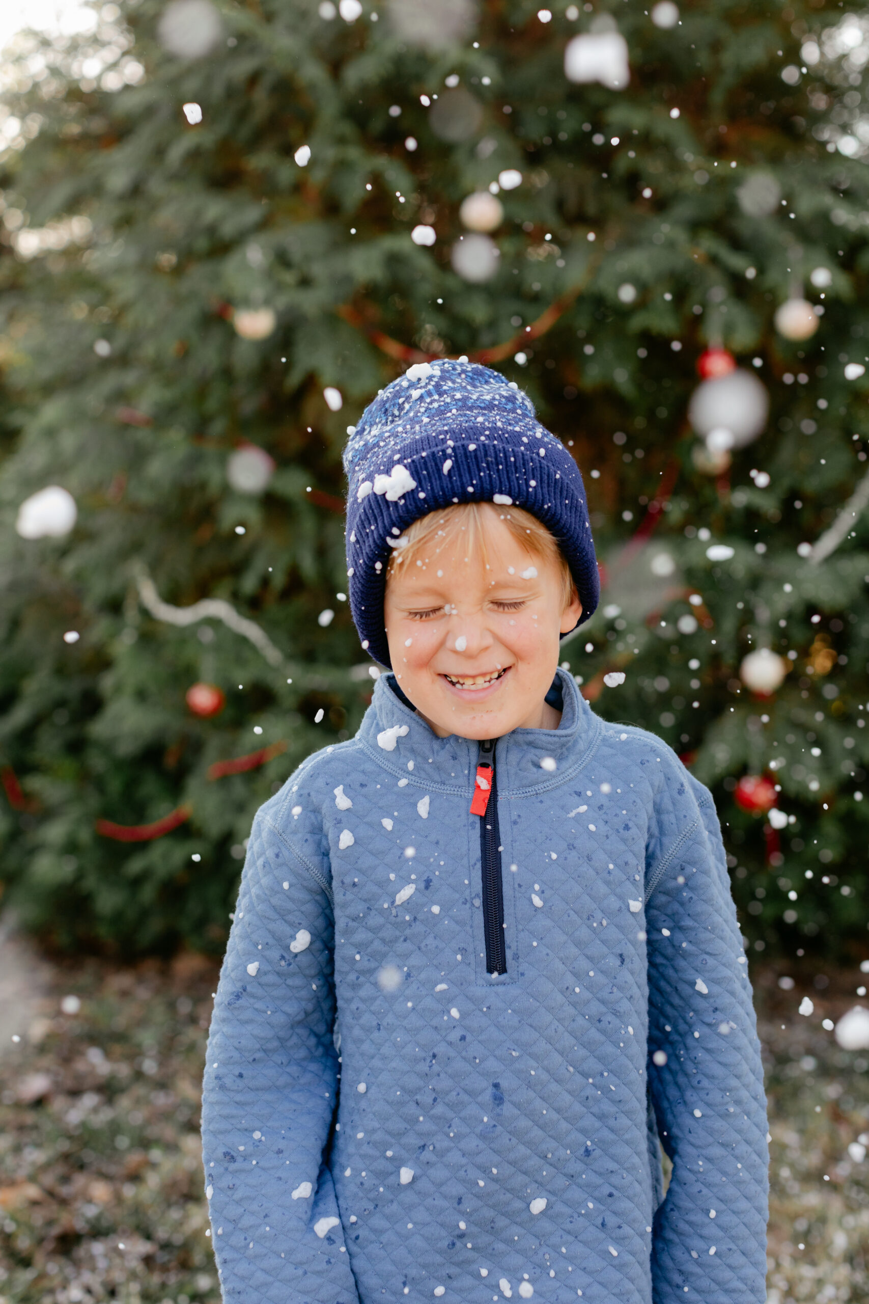 little boy in the snow. christmas themed family photos in tennessee with fake snow