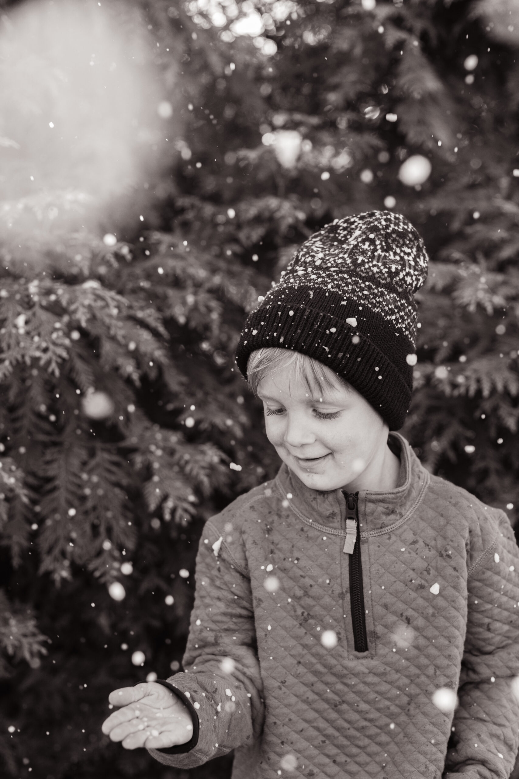 little boy in the snow. christmas themed family photos in tennessee with fake snow