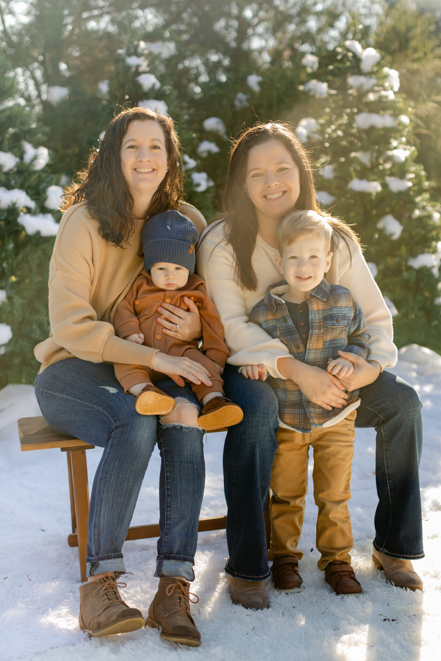 two mom and their sons. snowy christmas family photos