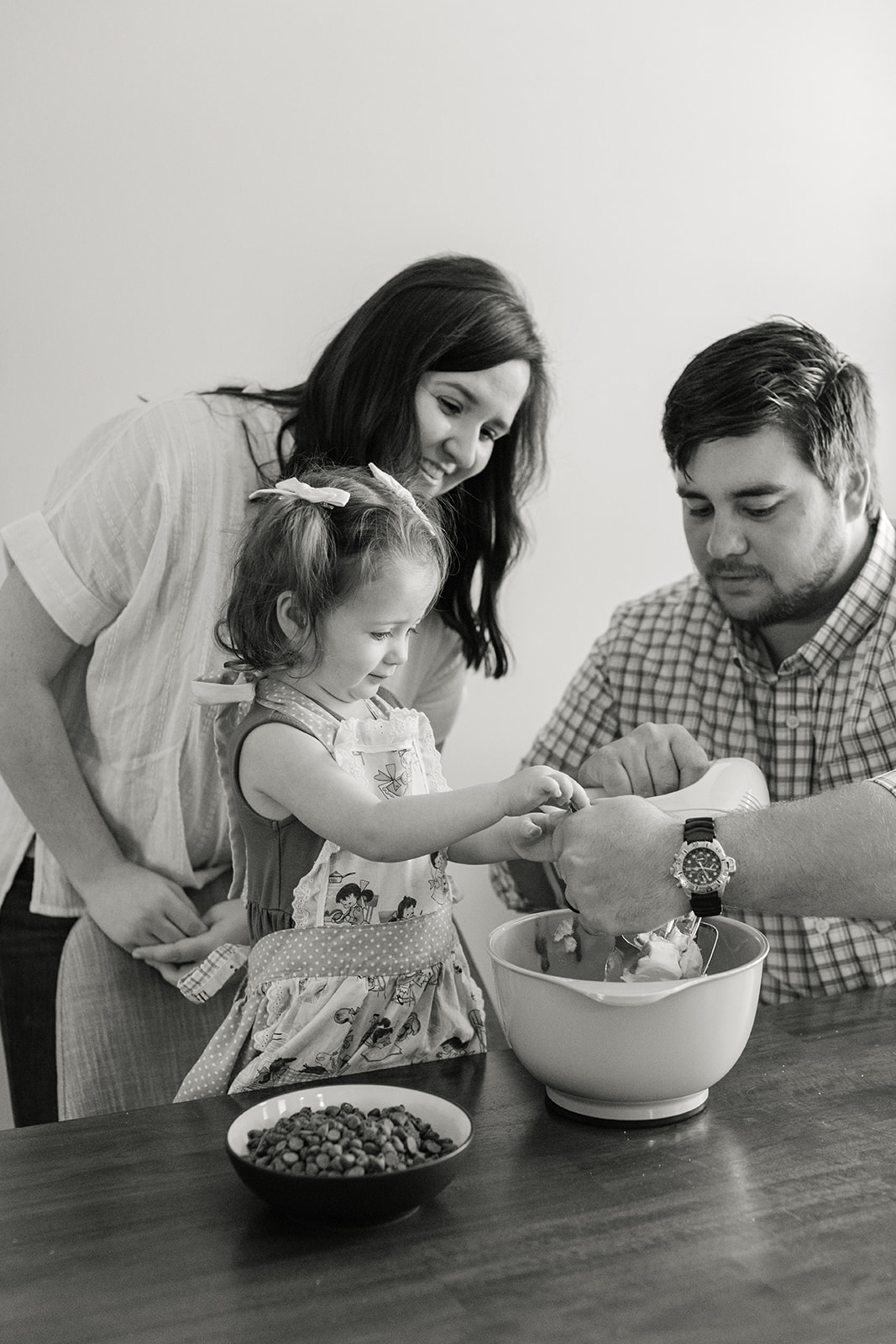 little girl and parents baking cookies