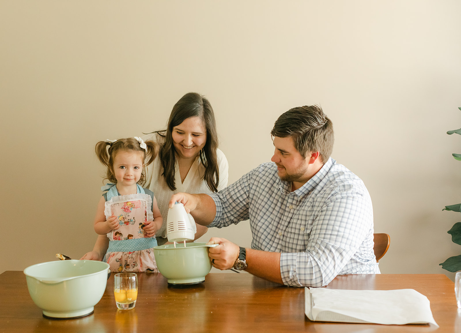 little girl and parents baking cookies