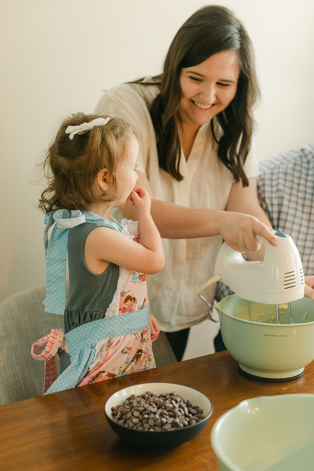 little girl and parents baking cookies