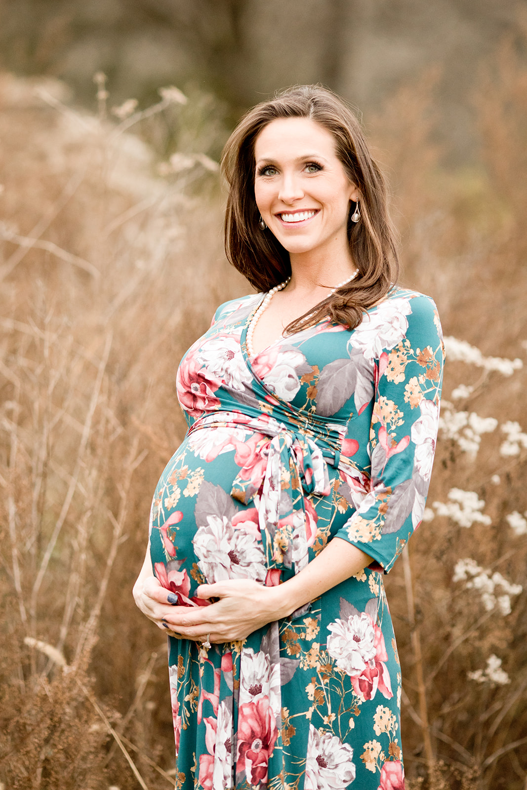 mama posing. outdoor maternity session in grassy field