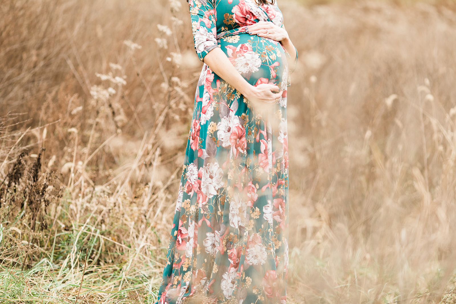 mama posing. outdoor maternity session in grassy field