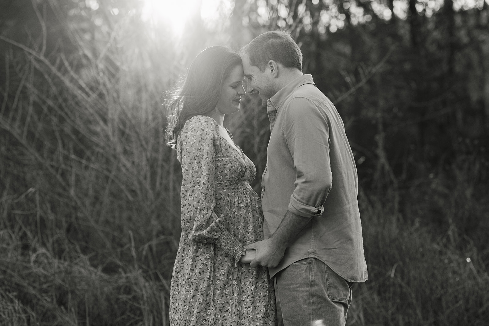 couple posing. sunset maternity session on big hill