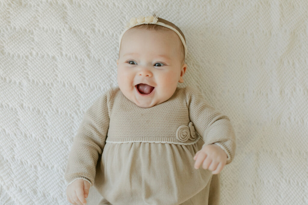 Smiling baby girl. 3 month old baby milestone session