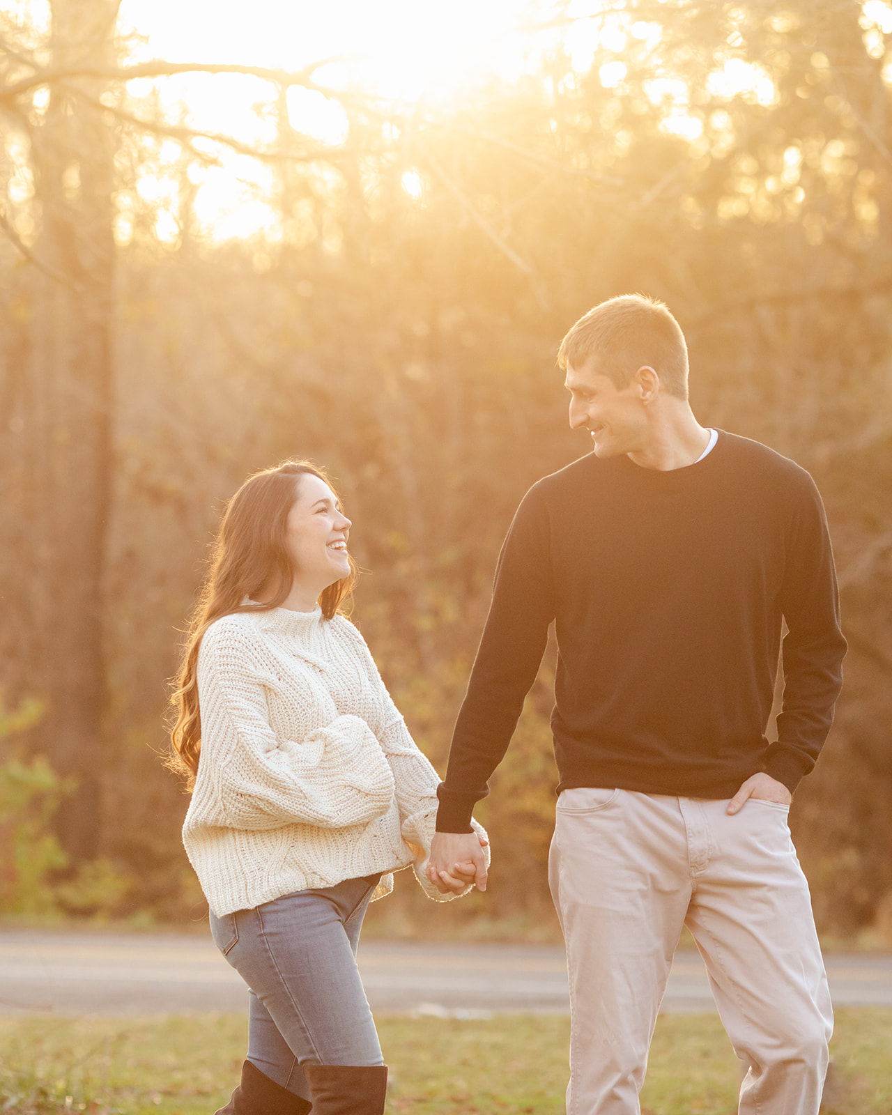 couple walking holding hands. outdoor sunset maternity photo