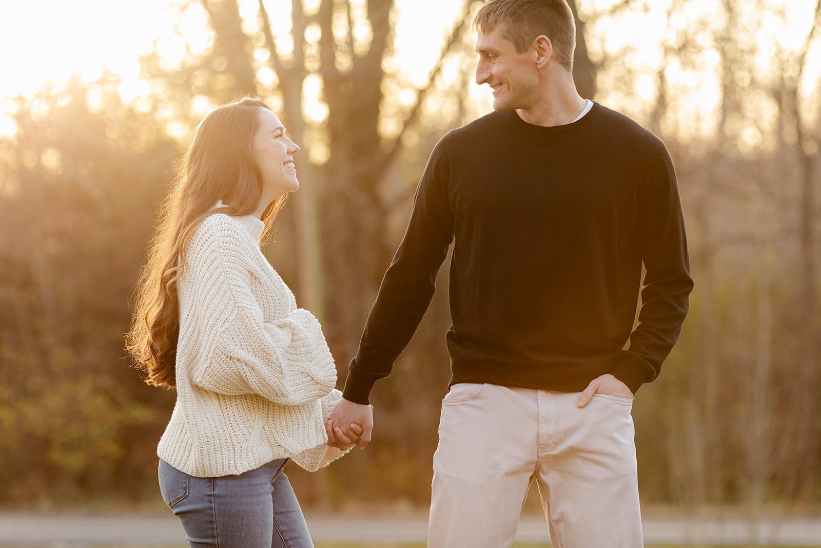 An expectant couple poses for maternity photos in golden hour light of sunset outside a photographer's studio in Nashville, Tn. 