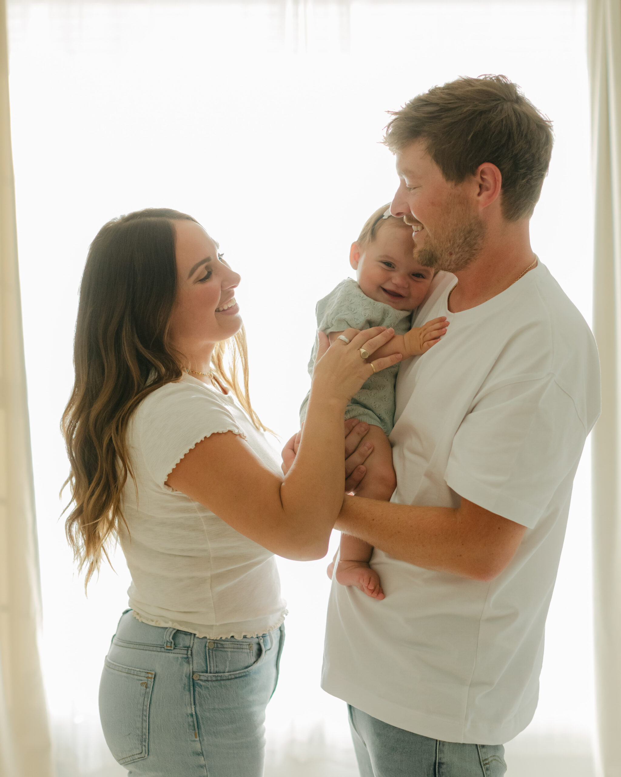 parents with baby girl. studio family photos.