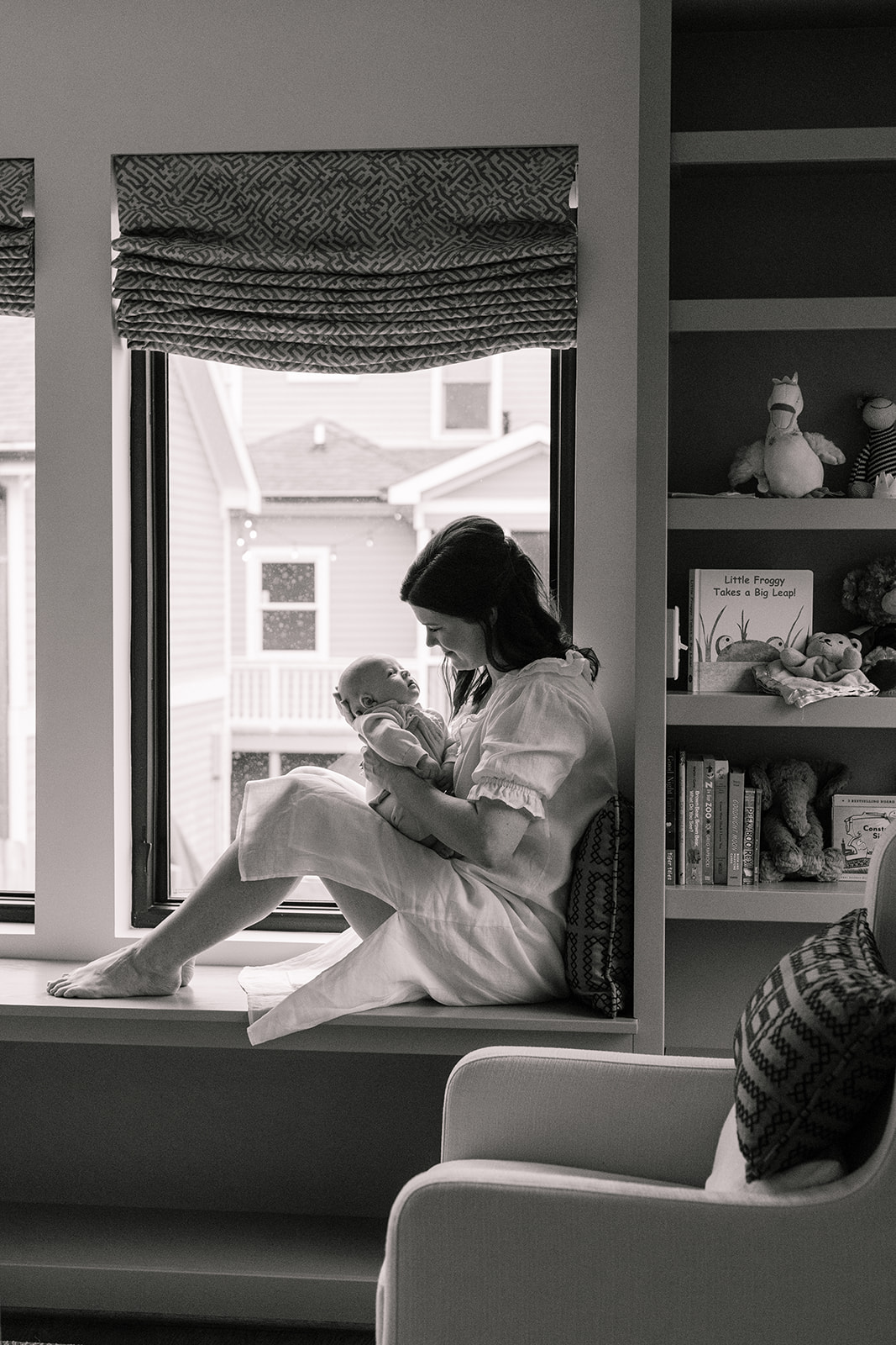 mama and newborn son in nursery