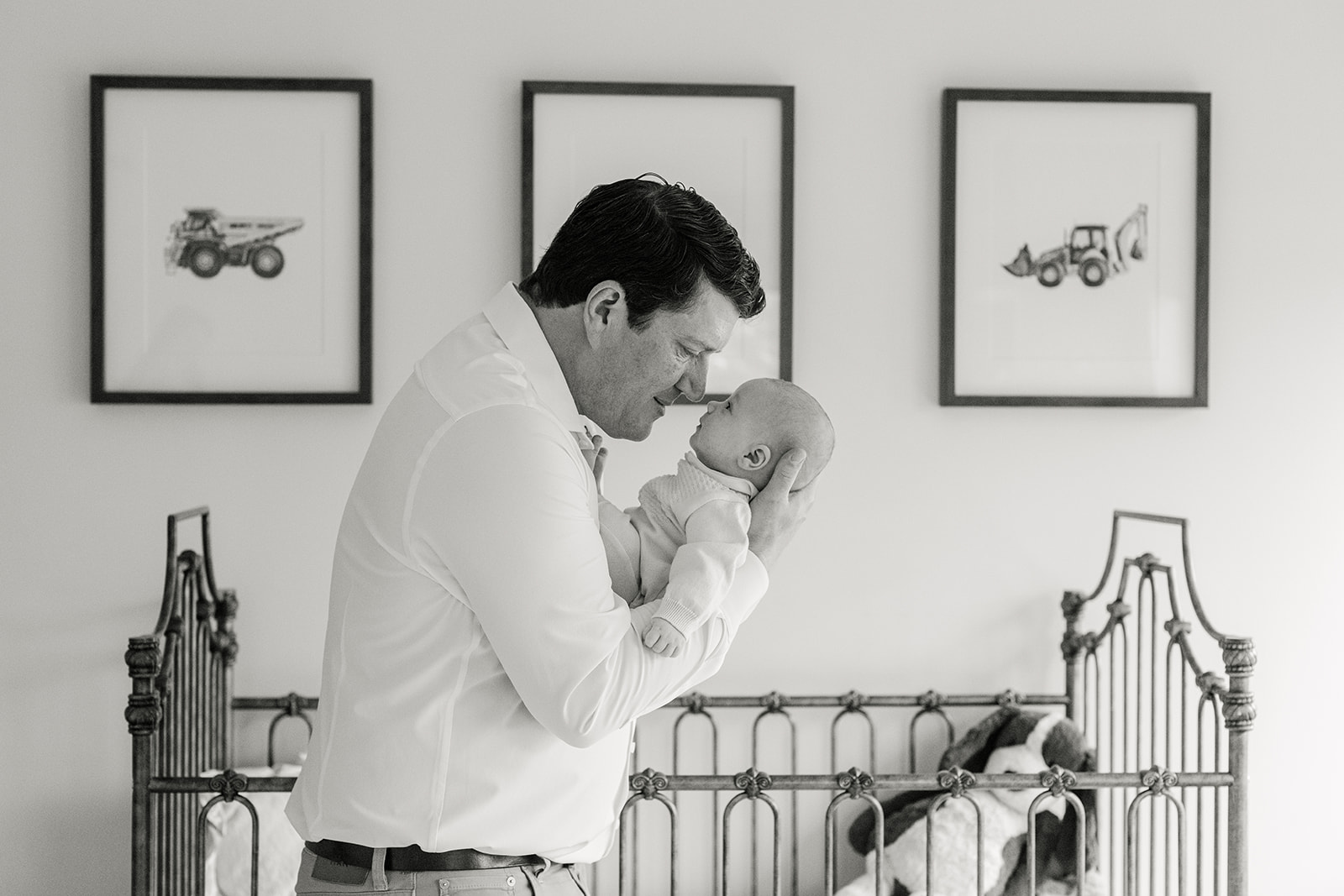 dad with newborn son in nursery