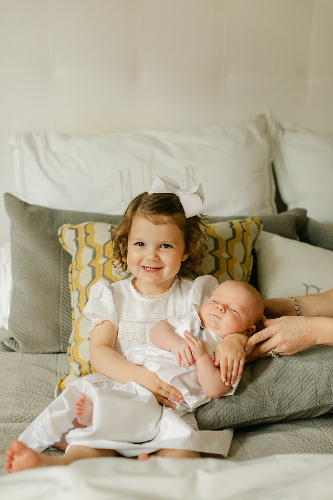 little sister with newborn baby brother