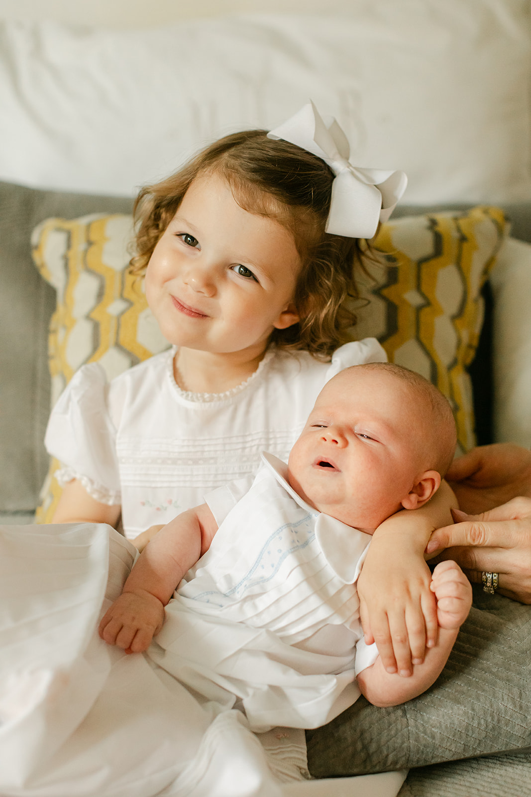 little sister with newborn baby brother