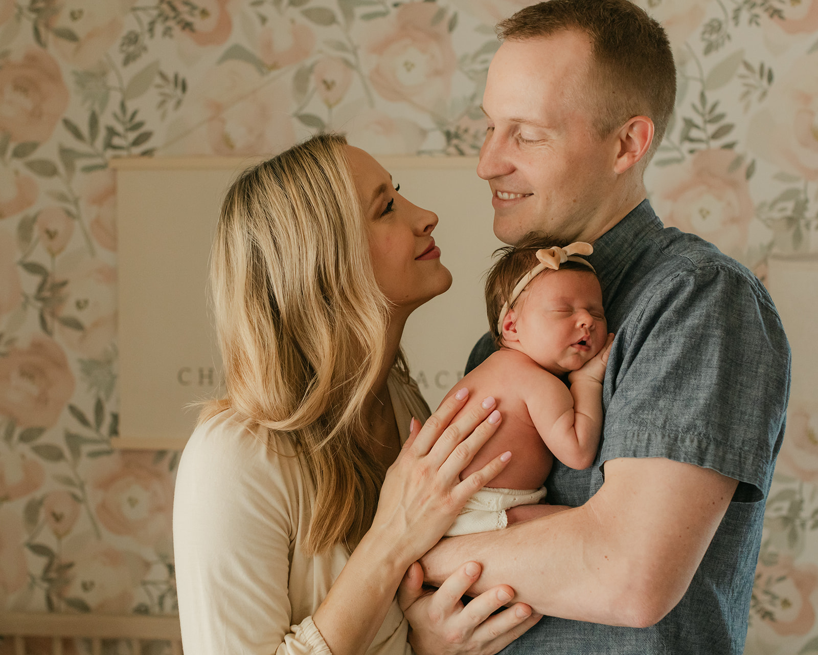 parents with newborn daughter. newborn session in nursery