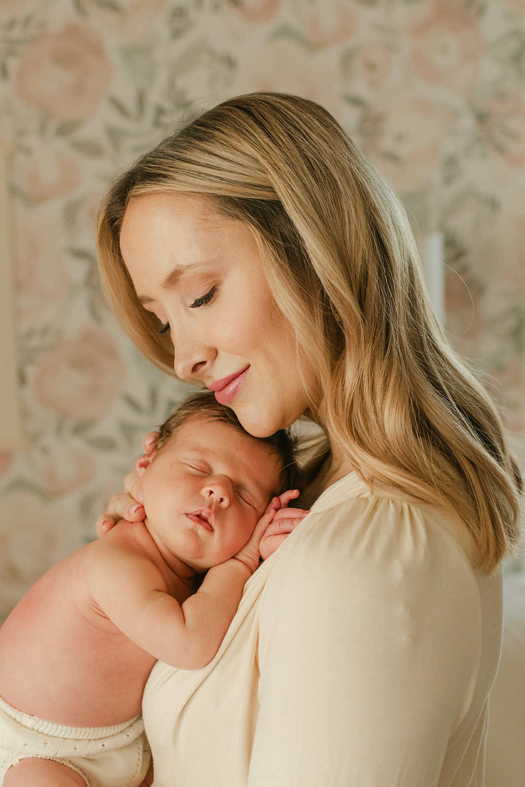 mama and newborn daughter. newborn session in nursery