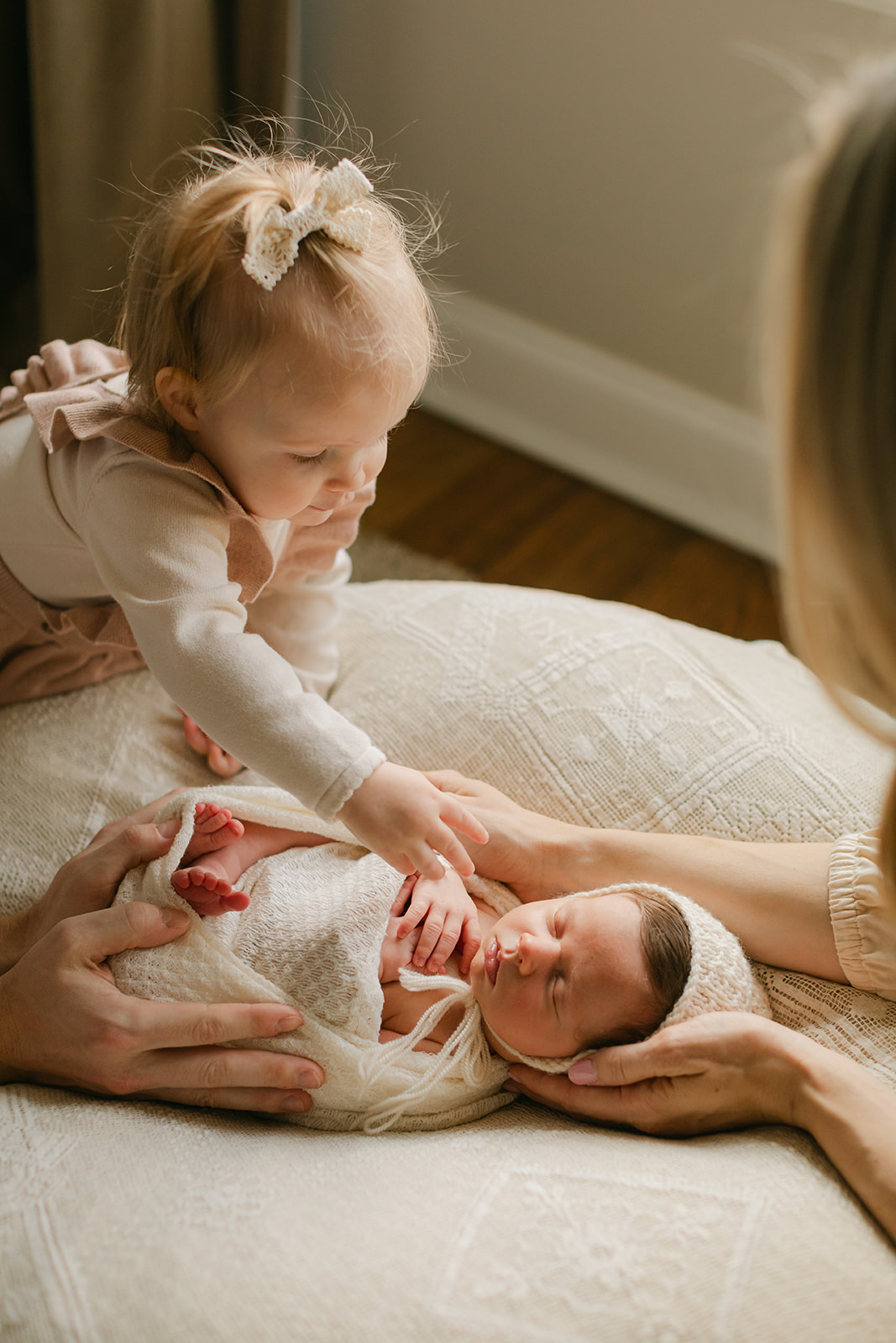 mama with her two daughters. newborn session in nursery