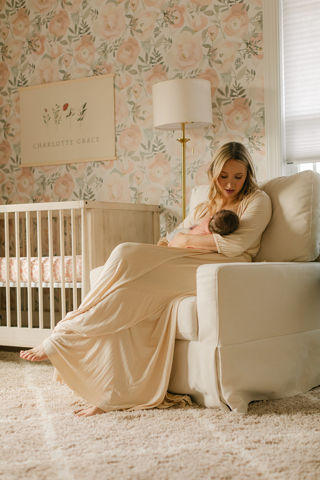 mama in nursery with newborn daughter 