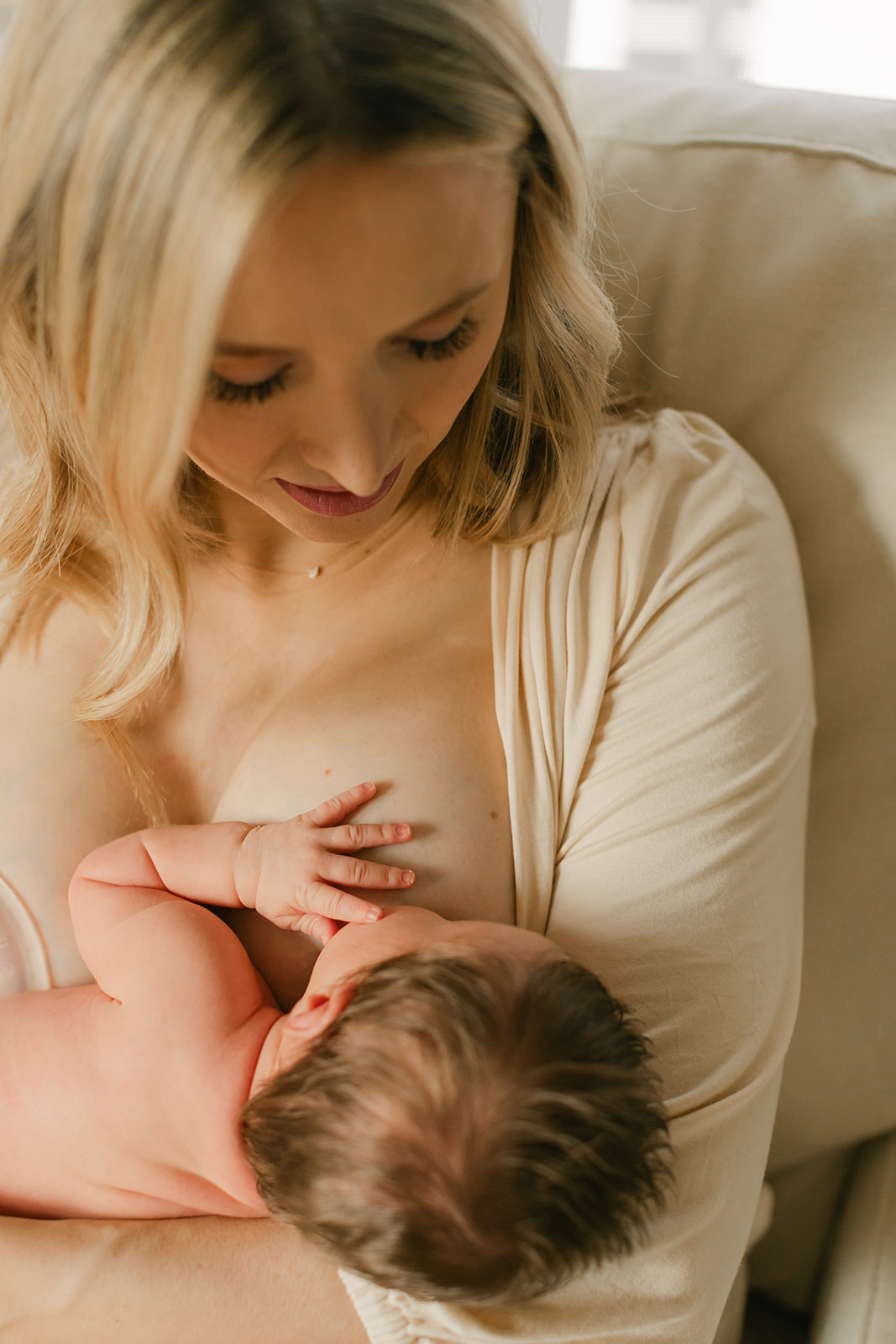 mama breastfeeding. newborn session in nursery