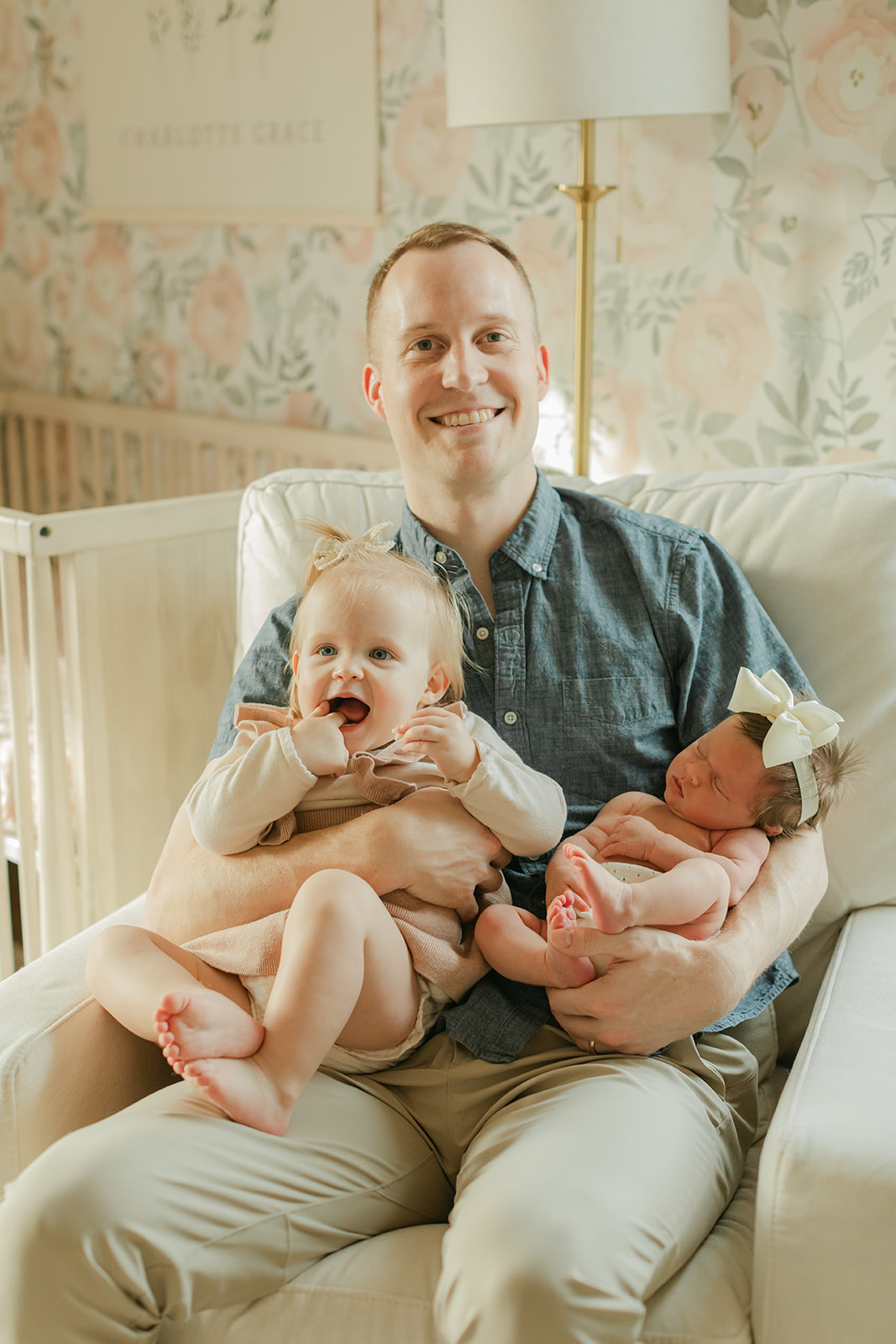 dad with daughters. newborn photo session in nursery 