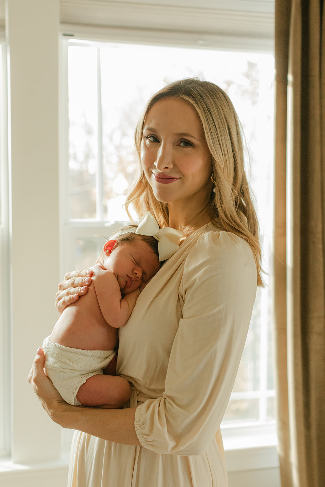 mama and baby girl. newborn photo session in nursery