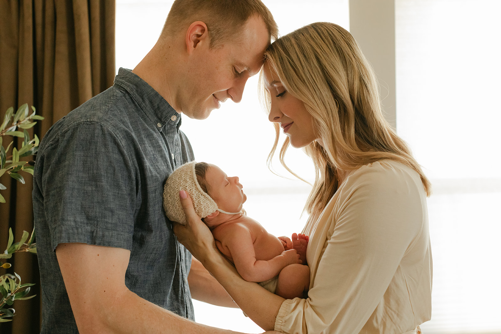 parents with newborn daughter. newborn session in nursery