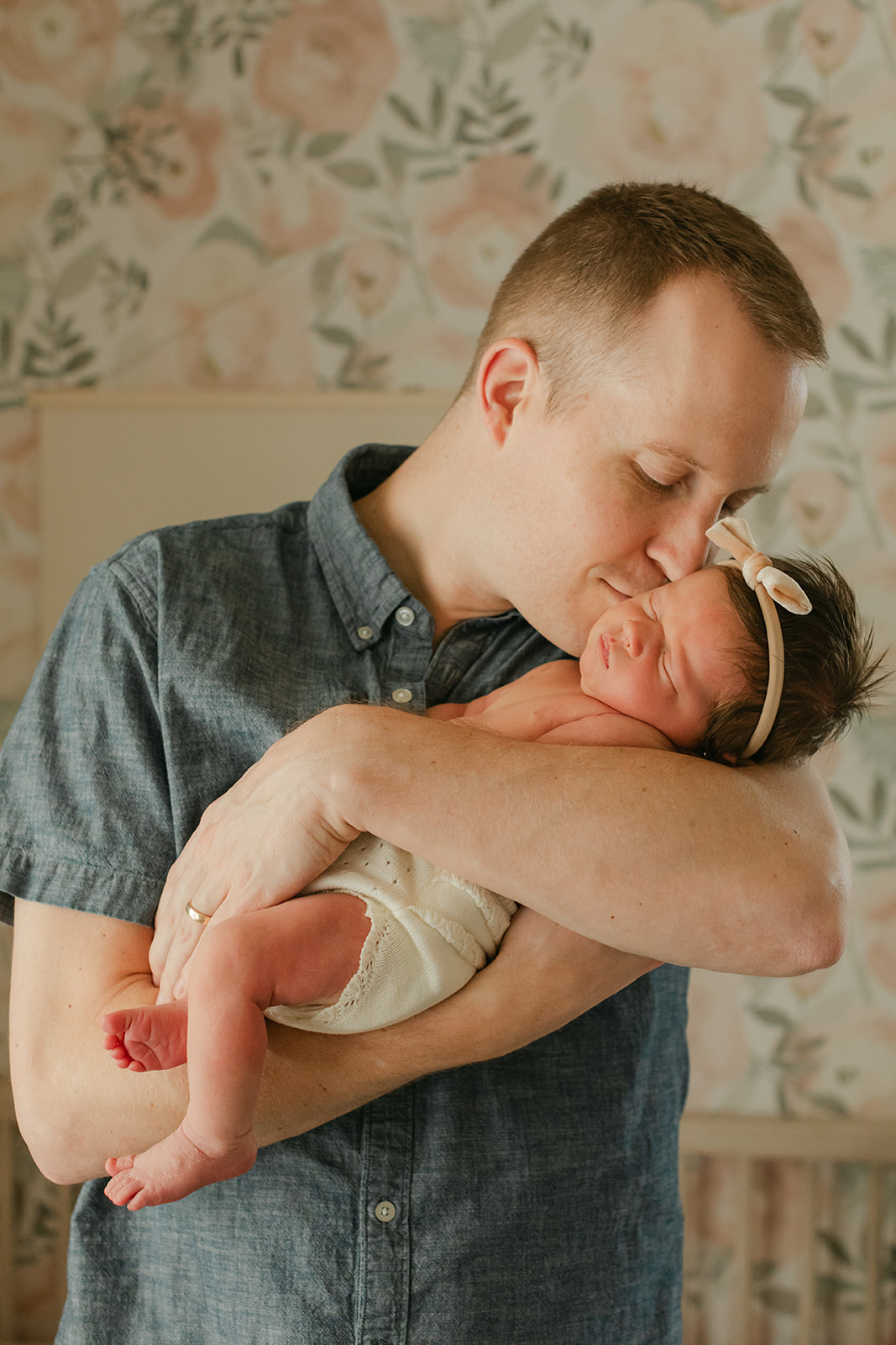 dad with newborn daughter. newborn session in nursery