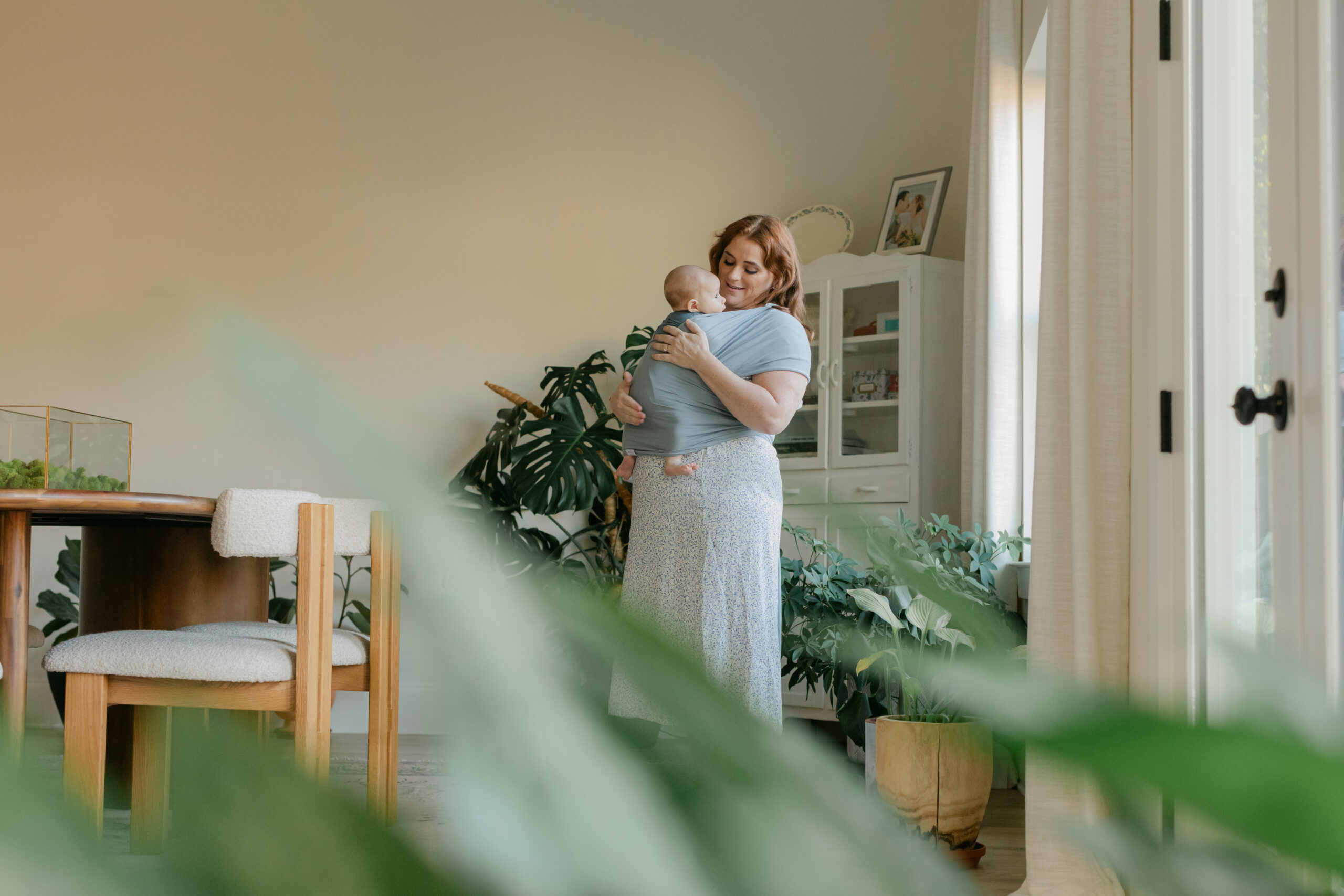 mama with newborn son in swaddle