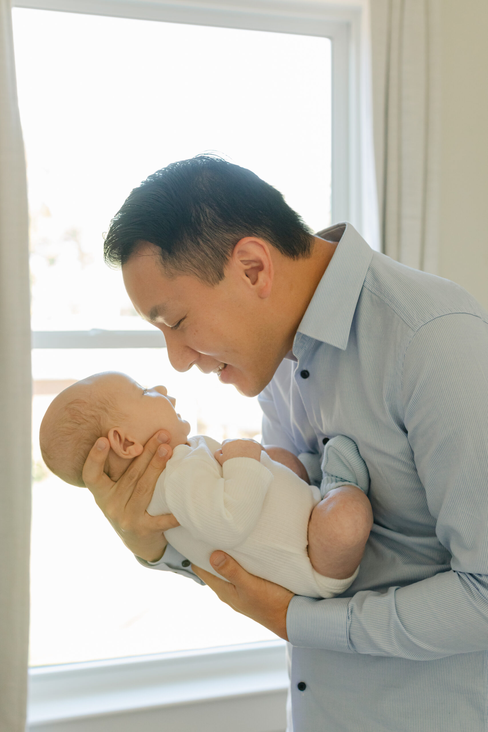 dad in nursery with newborn son