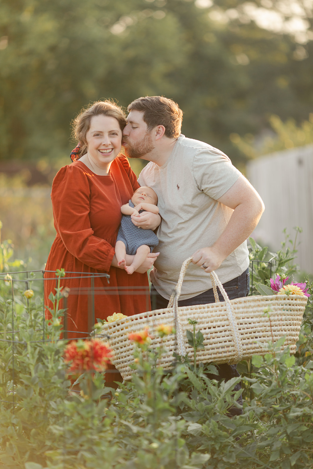 parents with newborn baby boy backyard photo