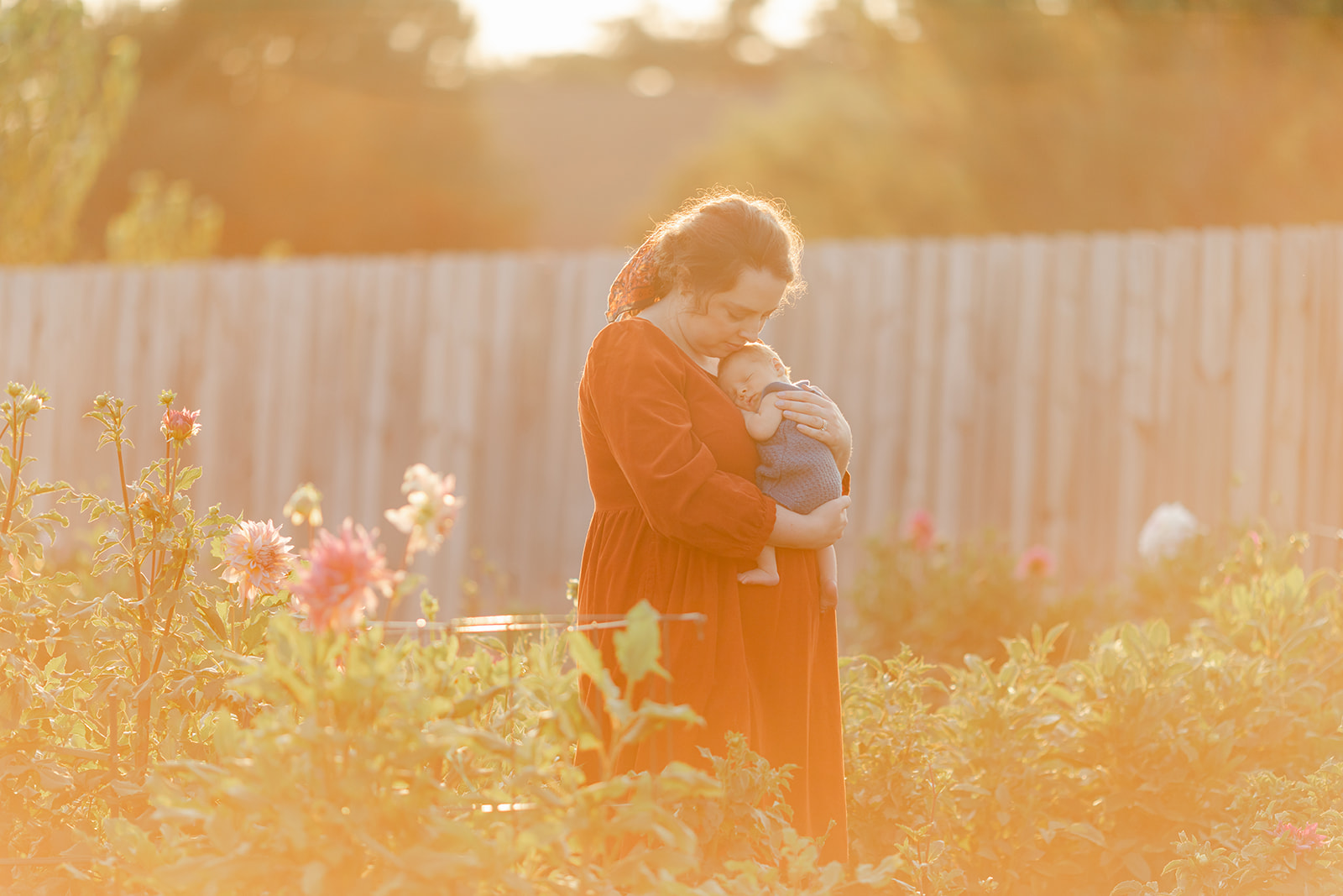 mom with newborn baby boy in backyard