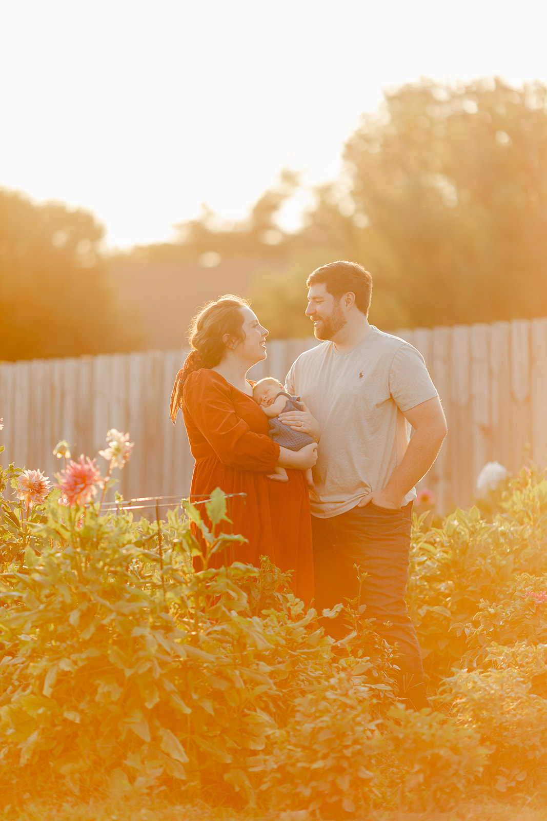 parents with newborn baby boy backyard photo
