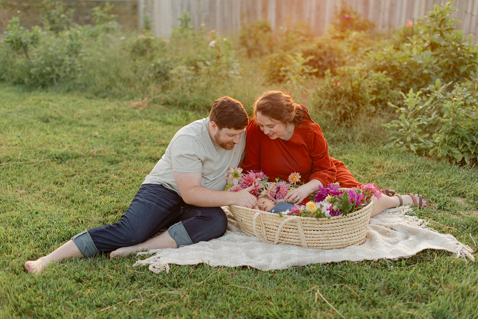 parents with newborn baby boy backyard photo