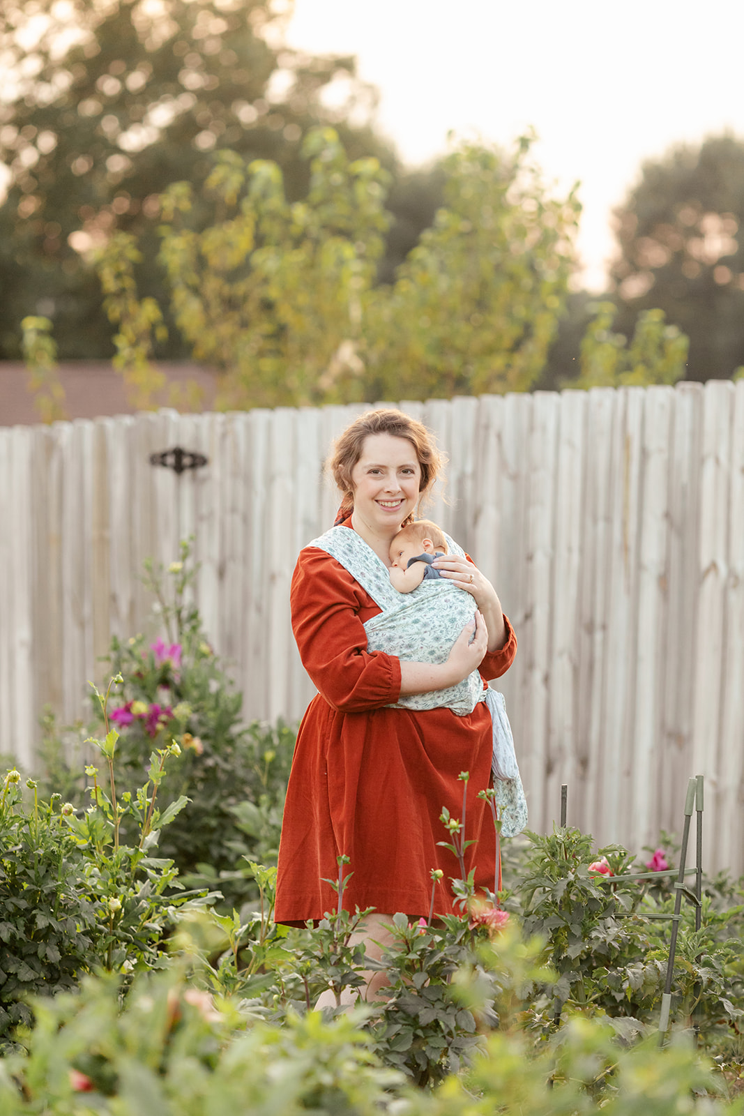 mom with newborn baby boy in backyard