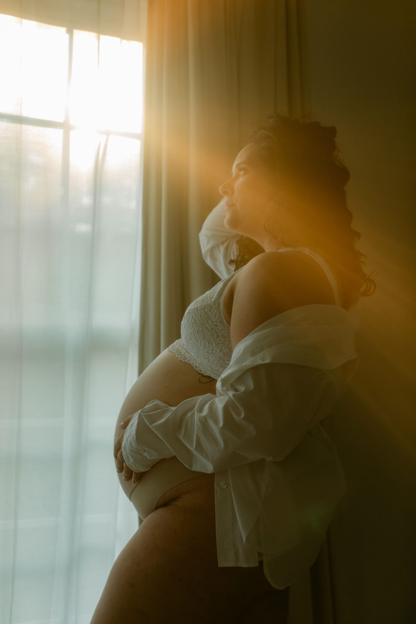 woman by window. solo maternity session