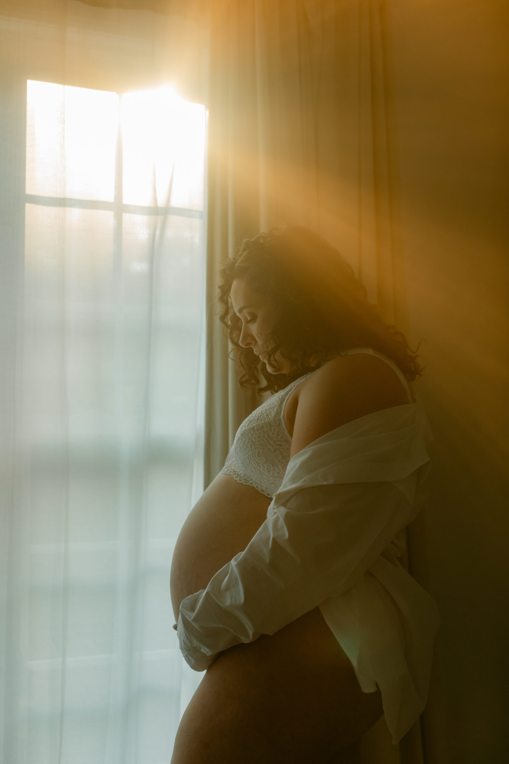 woman by window. solo maternity session