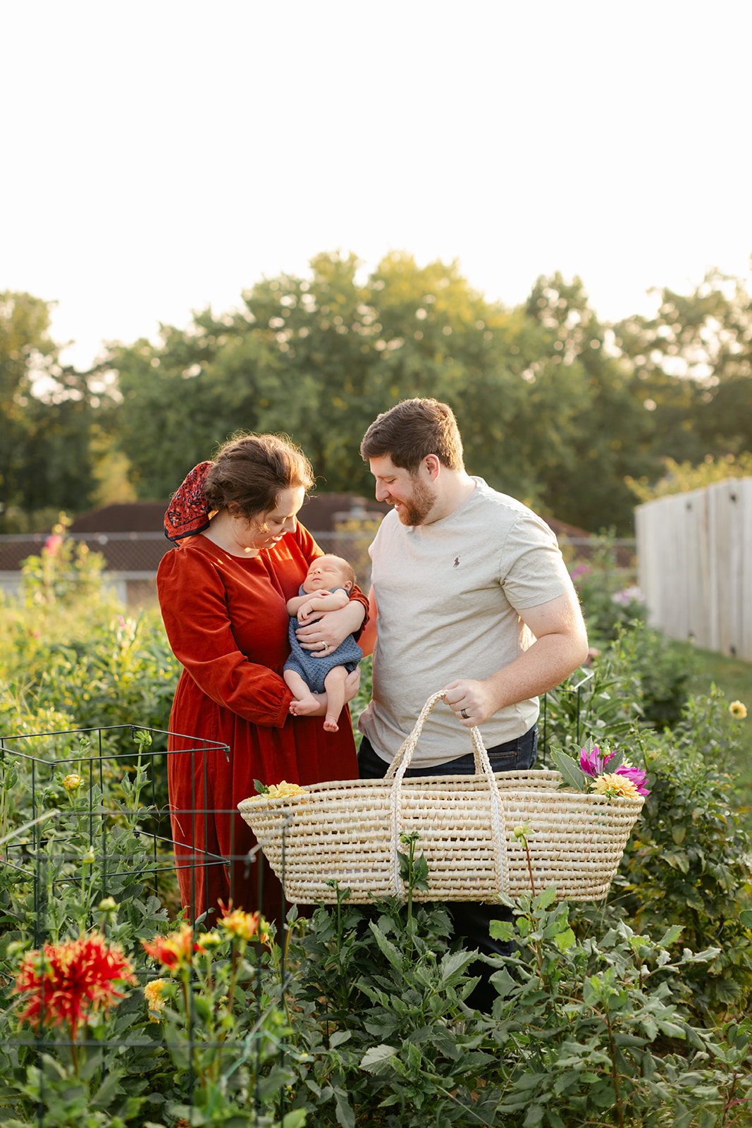 parents and newborn baby in garden
