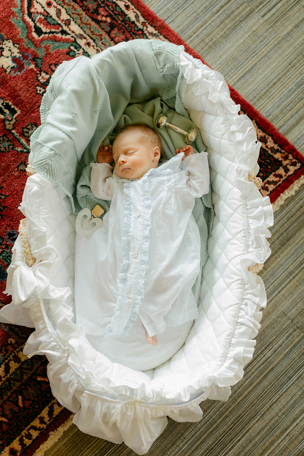 sleepy newborn baby in bassinet