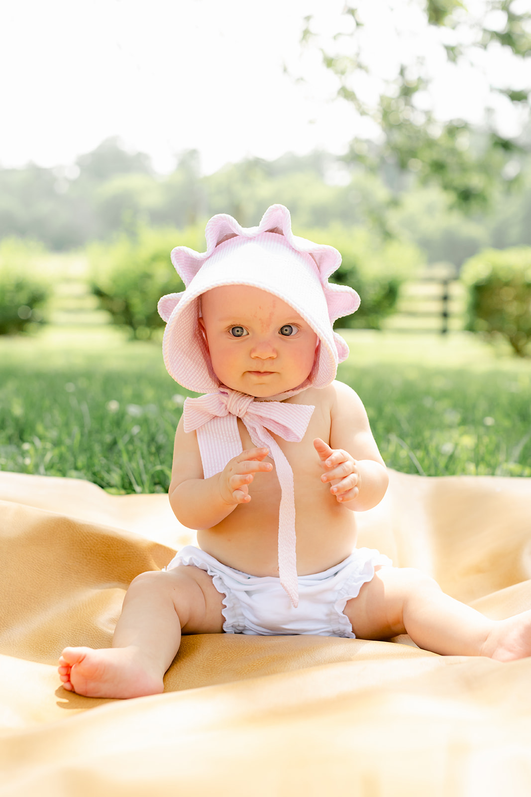 baby girl with pink bonnet