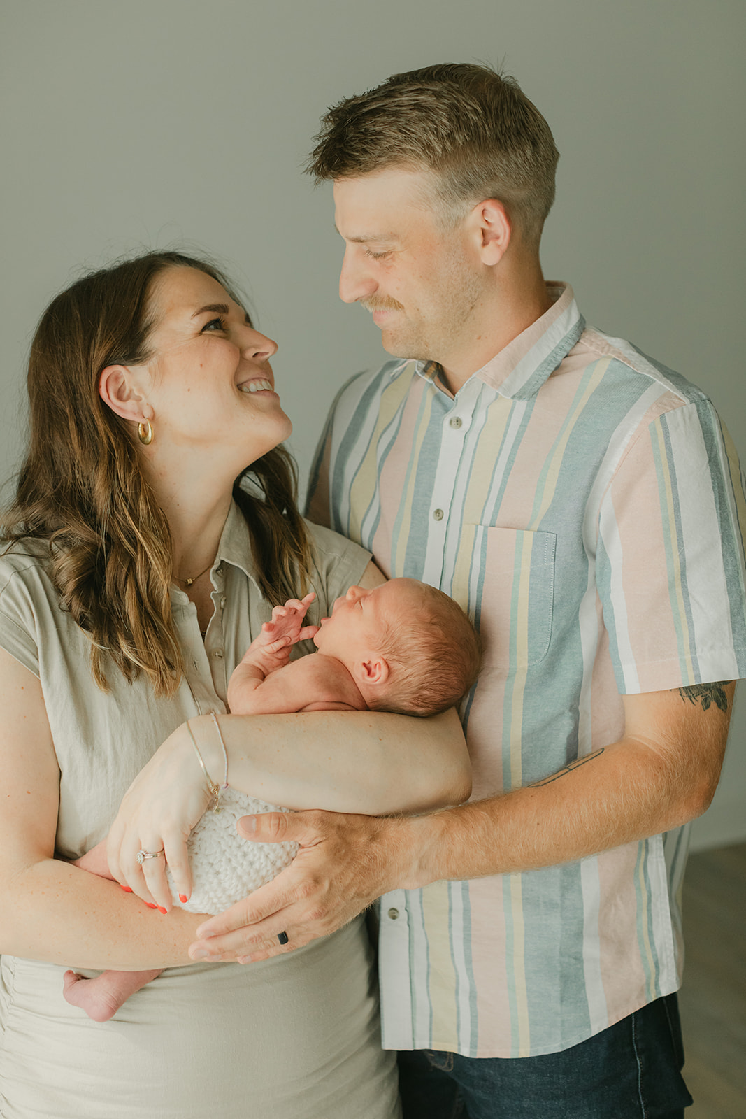 parents and sleepy newborn baby boy