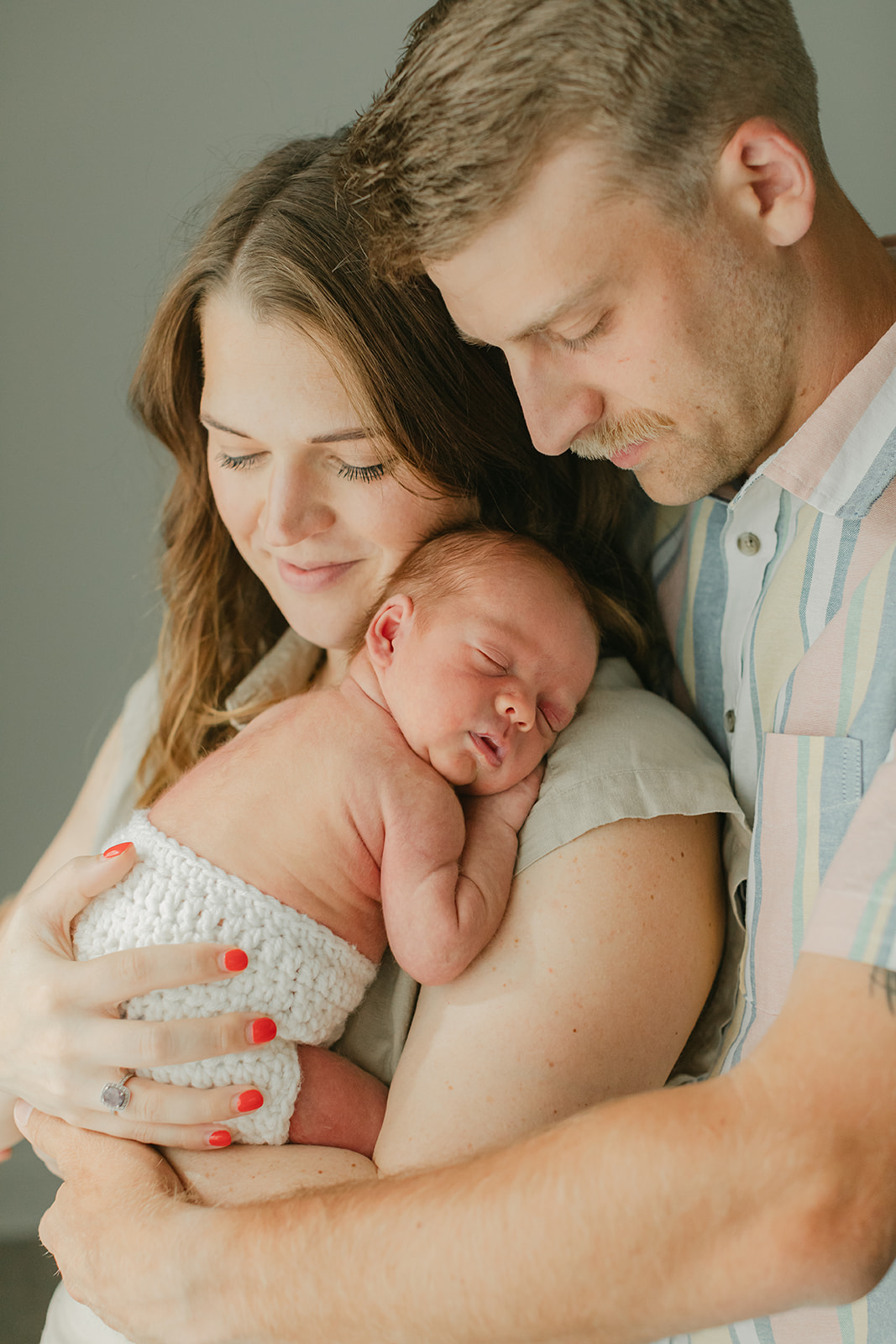 parents and sleepy newborn baby boy