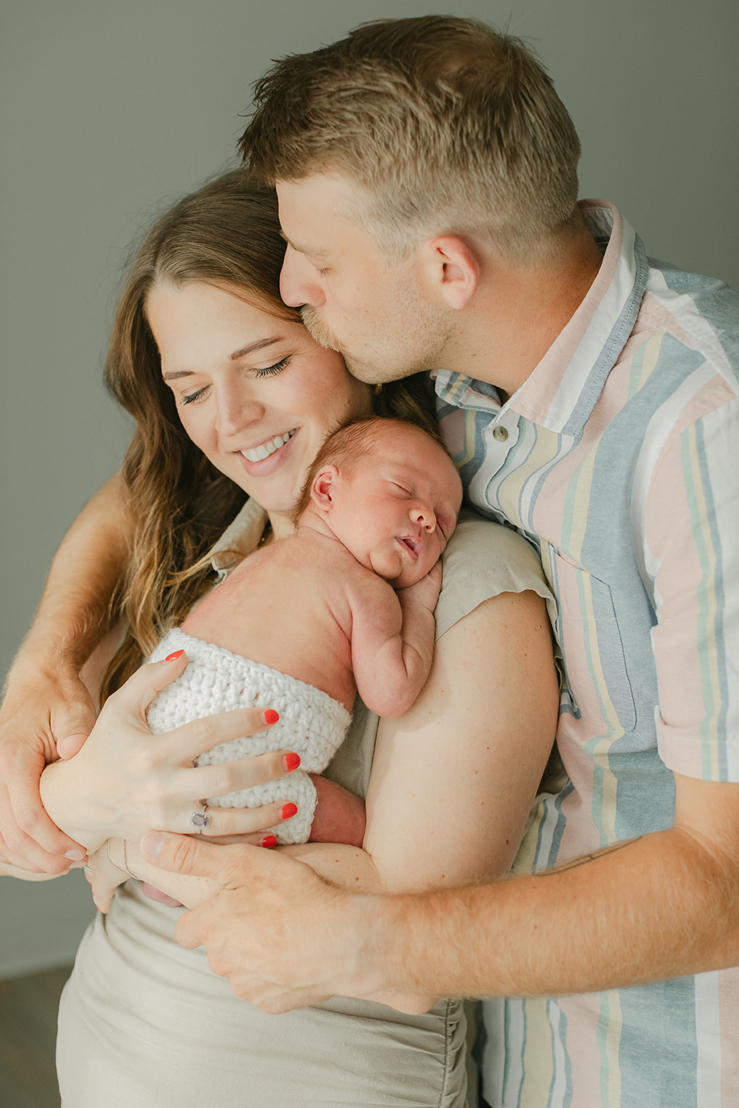 parents and sleepy newborn baby boy