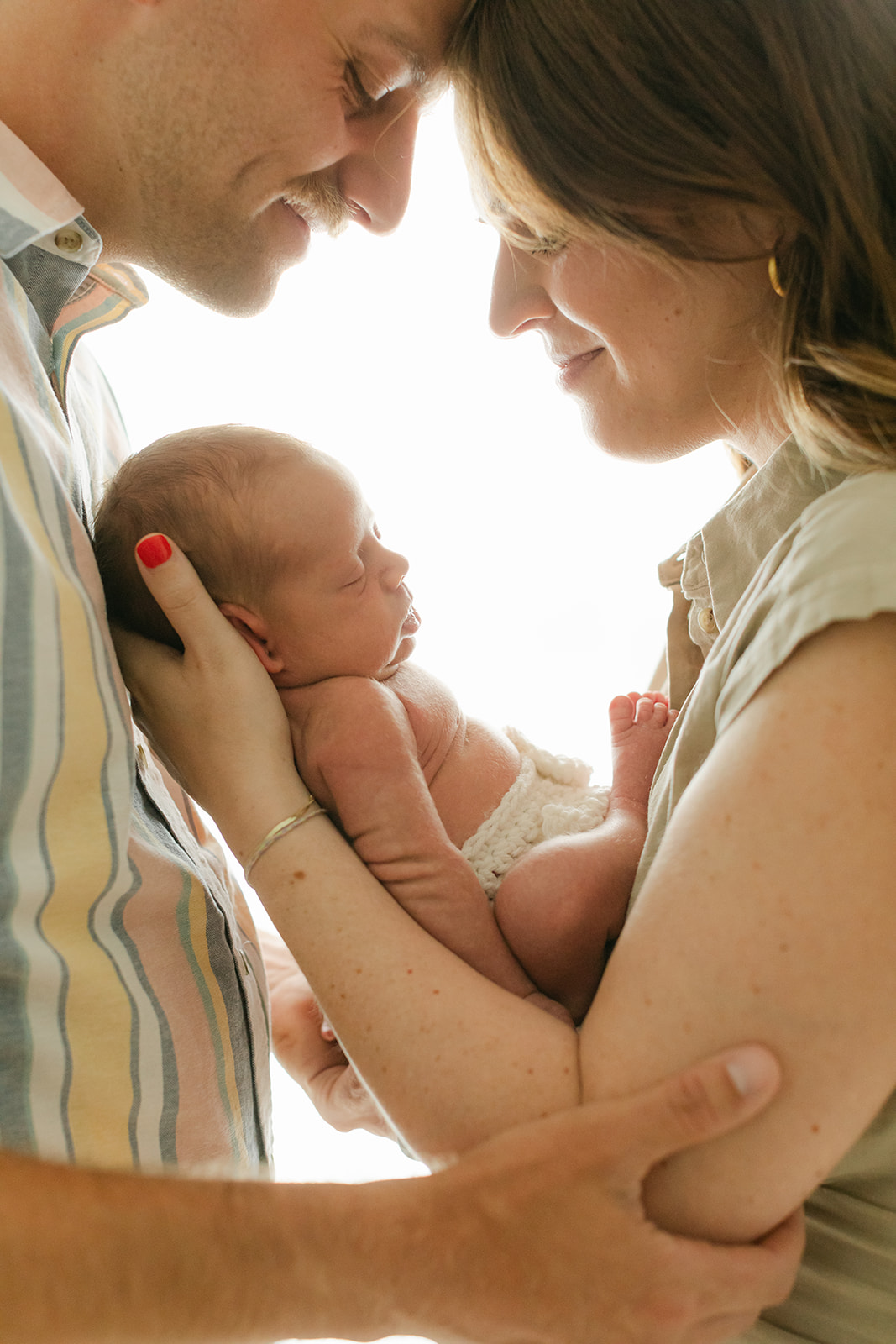 parents and sleepy newborn baby boy