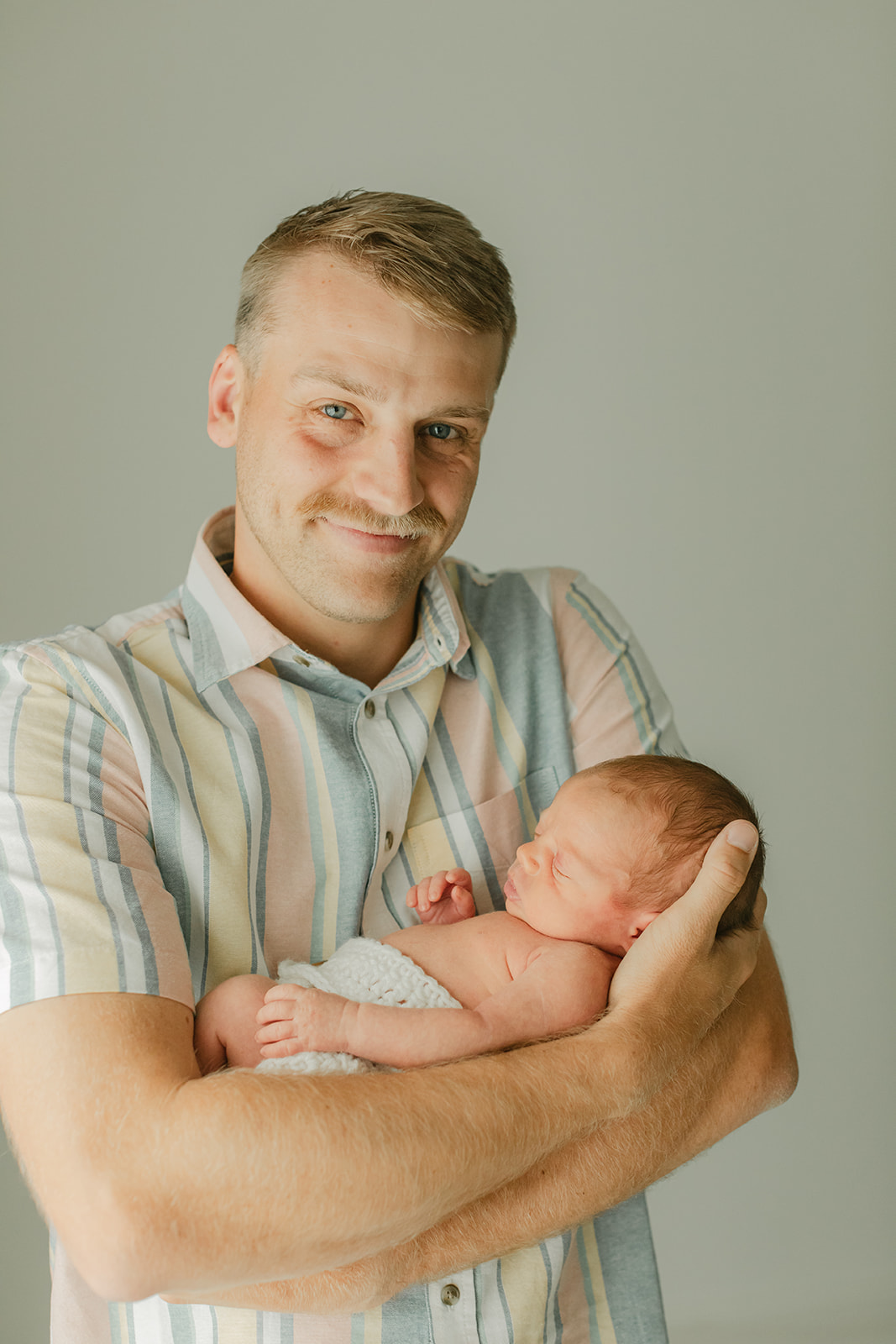 dad and sleepy newborn baby boy