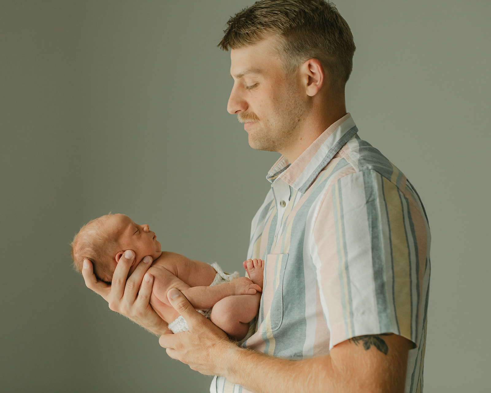 dad and sleepy newborn baby boy