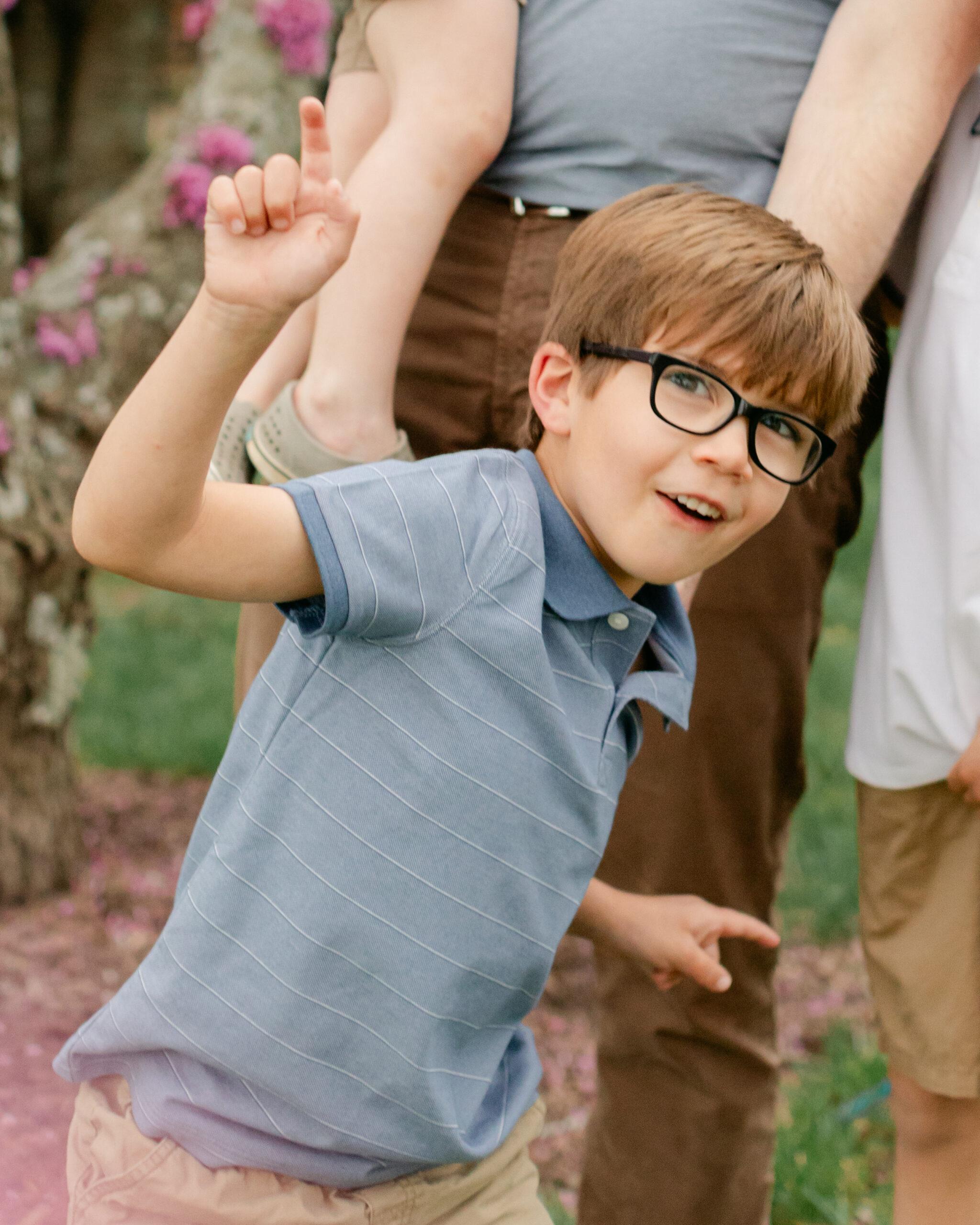 little boy with glasses. outdoor spring family photos. 
